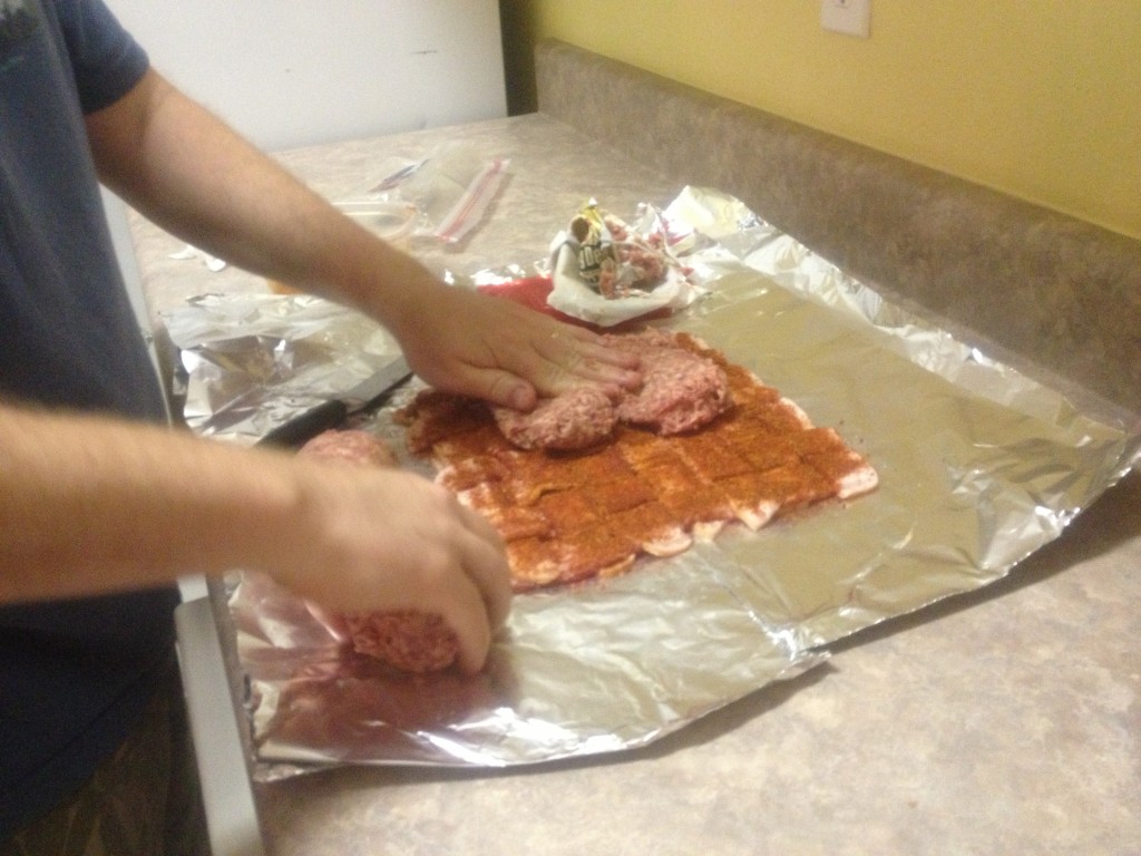 Then, smear the 2 lbs. of bulk sausage all the way across the woven bacon. Use your hands, it takes forever otherwise.
