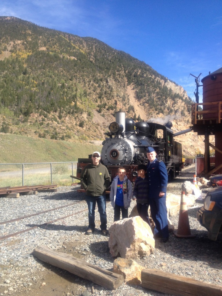 The token photo of the boys in front of a train.