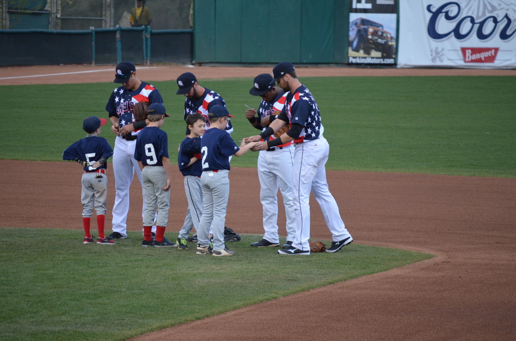 After the anthem, the Sky Sox players signed baseballs and gave them to the kids.
